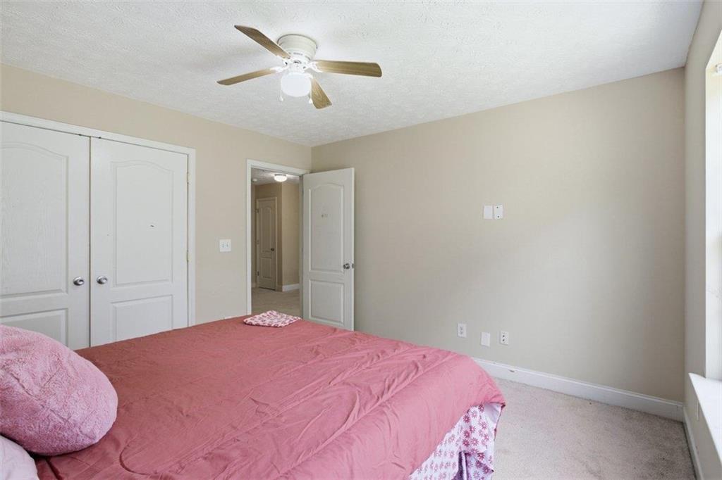 1231 Hillview Road Hampton, GA 30228 - Photo 28 of 49 a bedroom with a bed and a chandelier