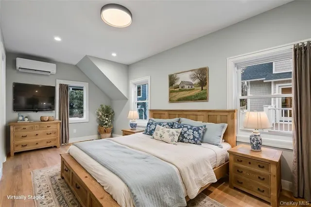 a bedroom with a bed and a flat screen tv