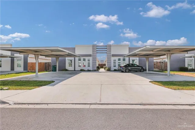 a view of multiple houses with a yard