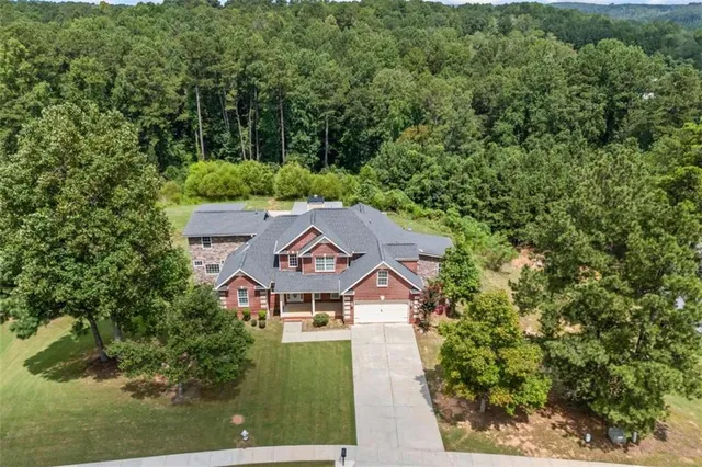 an aerial view of a house with a yard