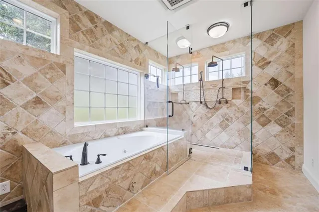 a bathroom with a granite countertop toilet a sink and bathtub