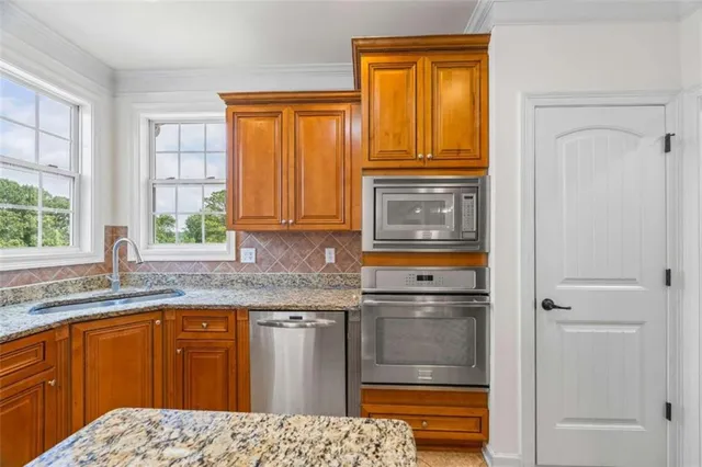 a bathroom with a granite countertop sink a mirror and a bathtub