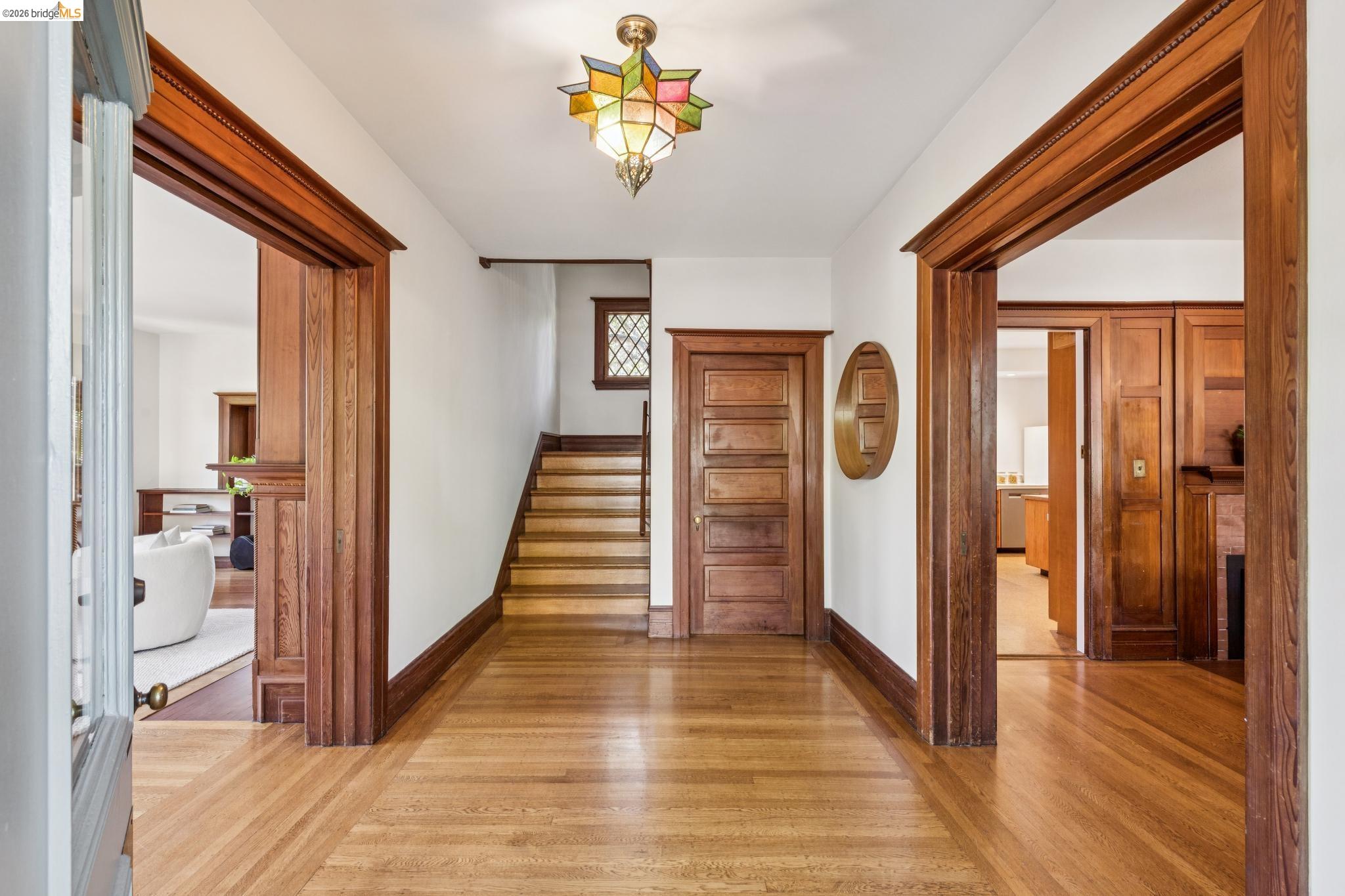 1490 Arch Street Berkeley, CA 94708 - Photo 6 of 57 a view of a hallway with wooden floor and staircase