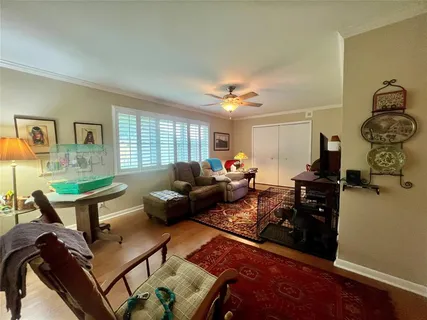 a living room with furniture a chandelier and a window