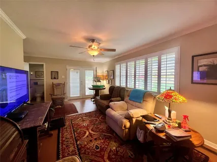 a living room with furniture flowerpot and window