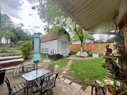 a view of backyard of house with seating space
