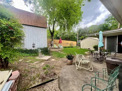 a view of backyard with seating space and plants