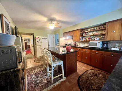 a kitchen with stainless steel appliances granite countertop a stove a sink dishwasher and cabinets
