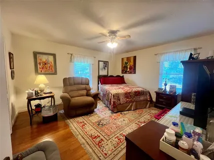 a bedroom with two beds and a couch