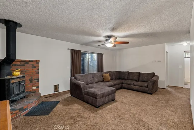 a living room with furniture and a ceiling fan