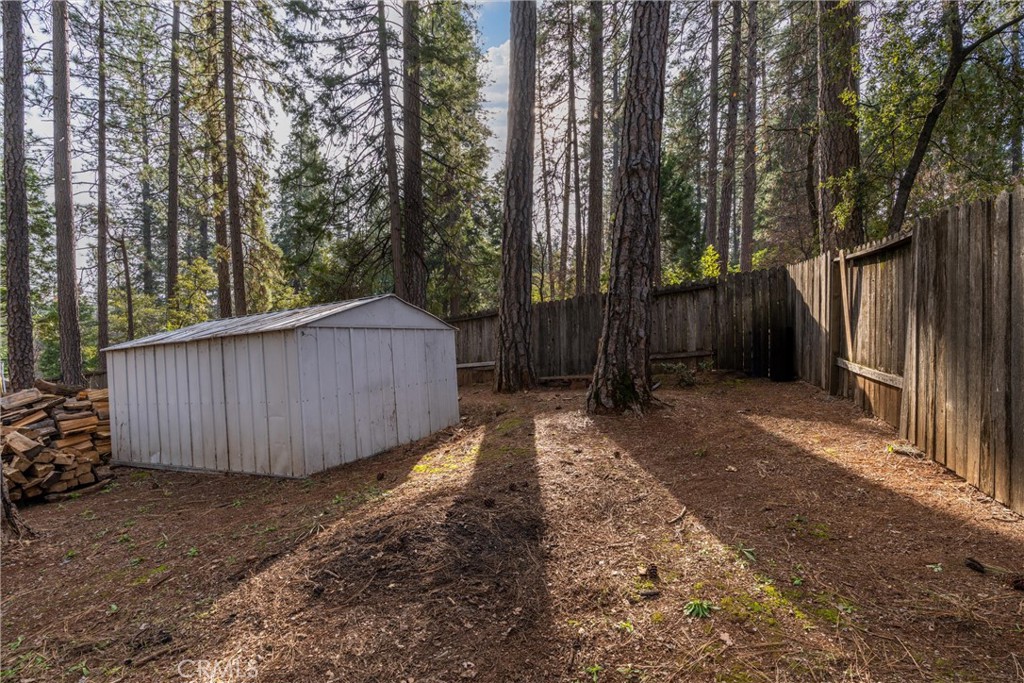 15353 Forest Ranch Way Forest Ranch, CA 95942 - Photo 29 of 47 a view of a backyard with large tree and wooden fence
