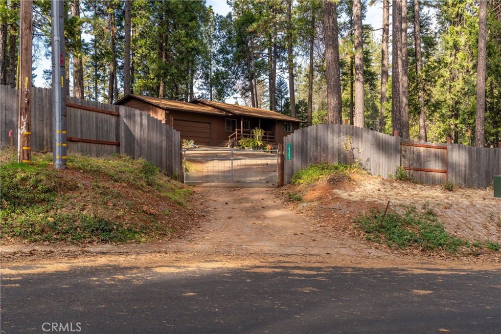 15353 Forest Ranch Way Forest Ranch, CA 95942 - Photo 47 of 47 a view of a backyard with large trees and wooden fence