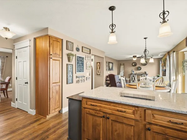 a view of a dining room with furniture large windows and wooden floor