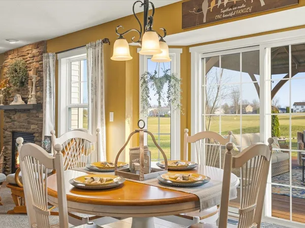 a kitchen with stainless steel appliances kitchen island granite countertop a table and chairs in it