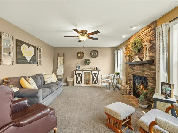 a living room with furniture and a chandelier