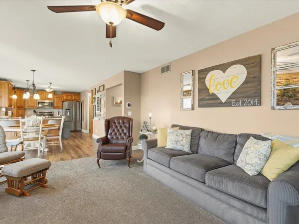 a bedroom with a large bed and a ceiling fan