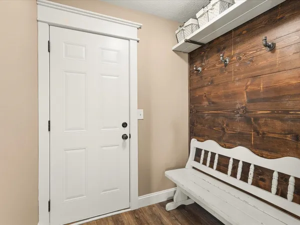 a bedroom with a bed chandelier and a window