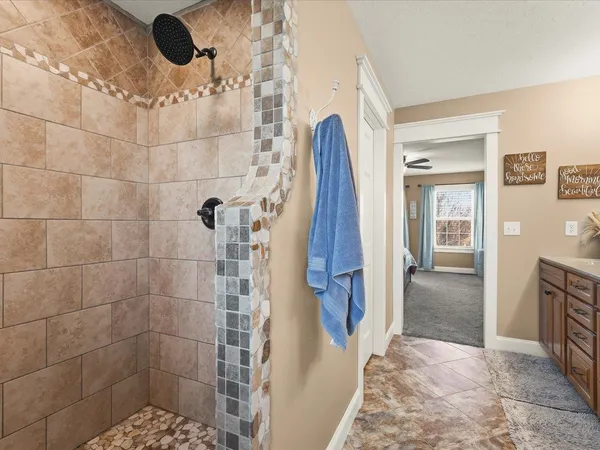 a bathroom with a sink toilet a mirror and shower curtain