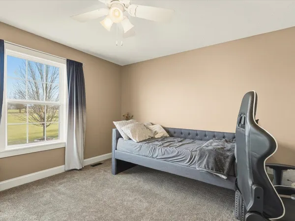 a bedroom with a bed and a chandelier