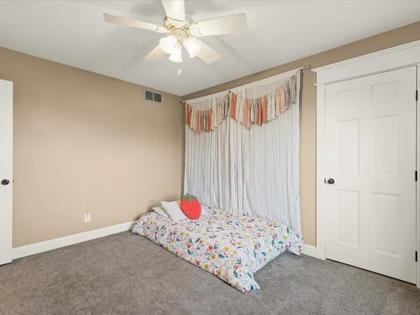 a bedroom with furniture and a flat screen tv