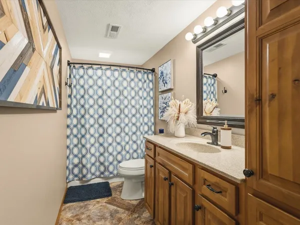a roof deck with couches and ocean view