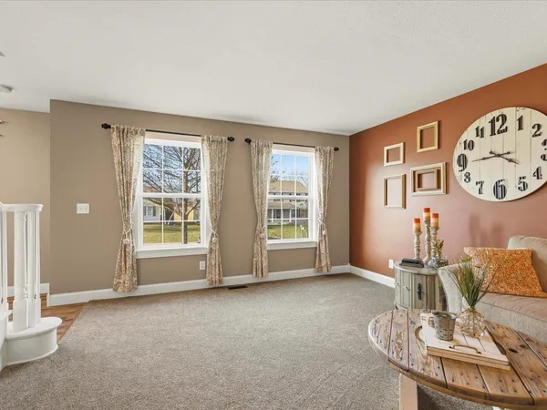 a living room with furniture and a clock