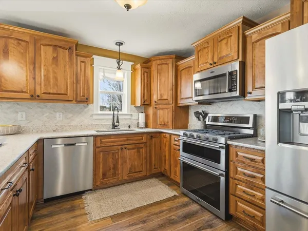 a kitchen with cabinets a sink and appliances