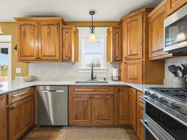 a kitchen with sink stove and cabinets
