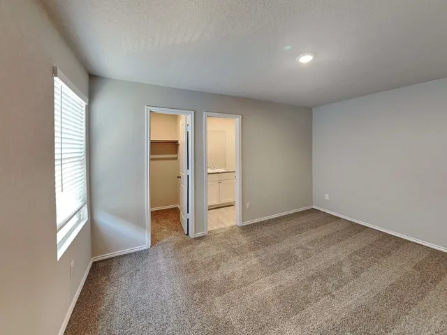 an empty room with closet area