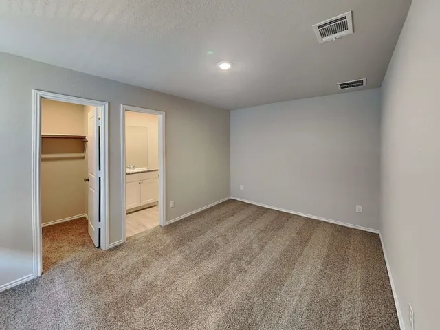 a bathroom with a granite countertop sink a toilet and mirror