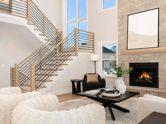 a living room with furniture a fireplace and a wall painting