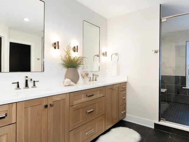 a bathroom with a double vanity sink and mirror