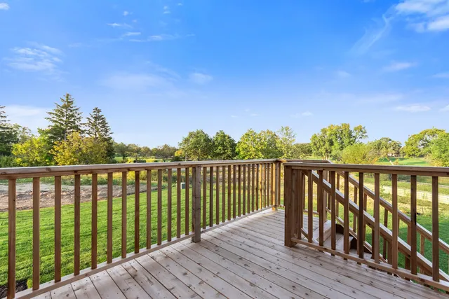 a balcony with wooden floor and fence