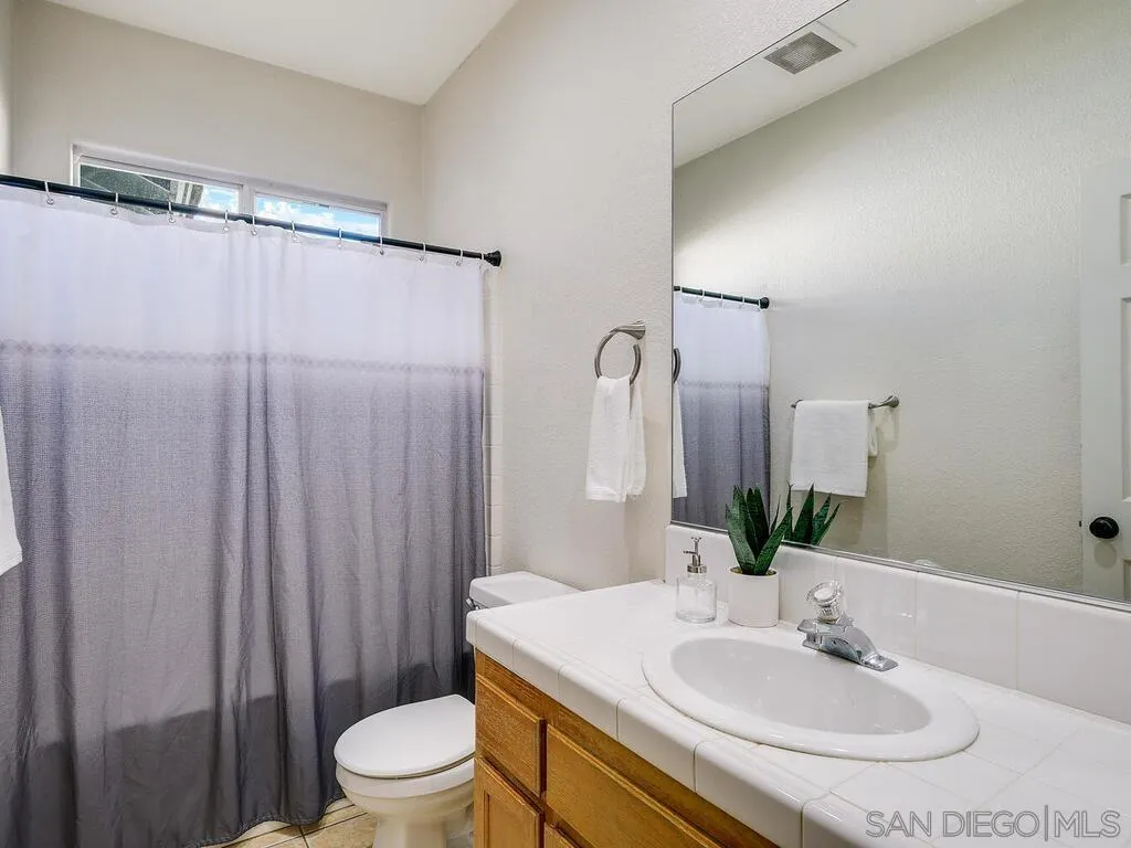 16304 Dartolo Road Ramona, CA 92065 - Photo 25 of 36 a bathroom with a sink toilet and shower