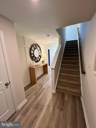 a view of entryway and hall with wooden floor