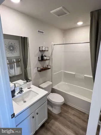 a bathroom with a sink toilet a mirror and shower