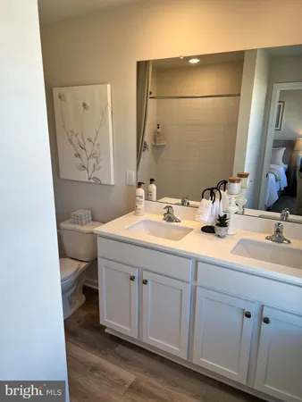 a bathroom with a sink a toilet and mirror