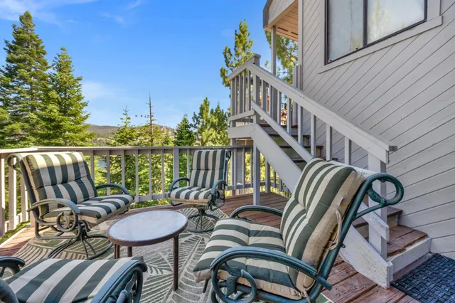 a balcony view with two chairs and a table