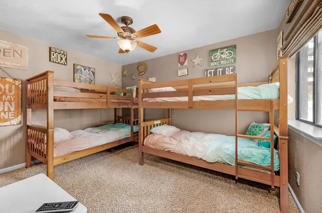 a bedroom with a bed and ceiling fan