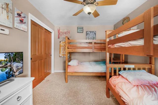 a bedroom with bed and a chandelier