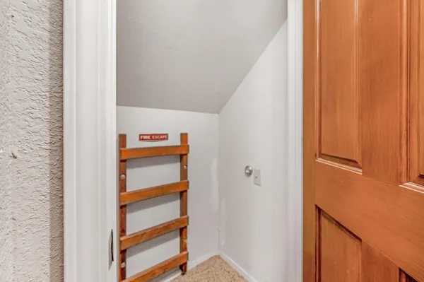 a front view of a house with a tree