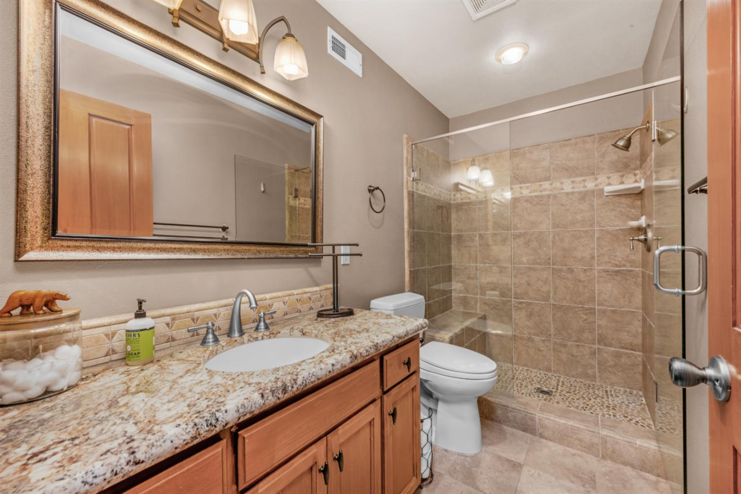 63217 Huntington Vista Road, Unit 81 Mono Hot Springs, CA 93642 - Photo 36 of 53 a bathroom with a granite countertop sink a toilet a mirror and shower