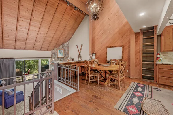 a dining room with furniture window and wooden floor