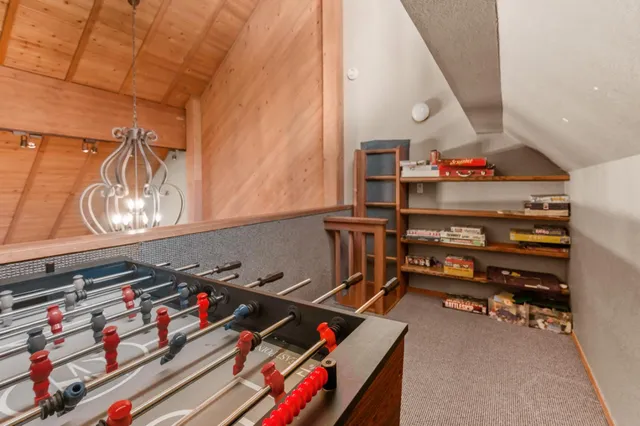 a white bench sitting in a room next to a window