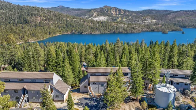 a view of a roof deck with wooden fence and a floor