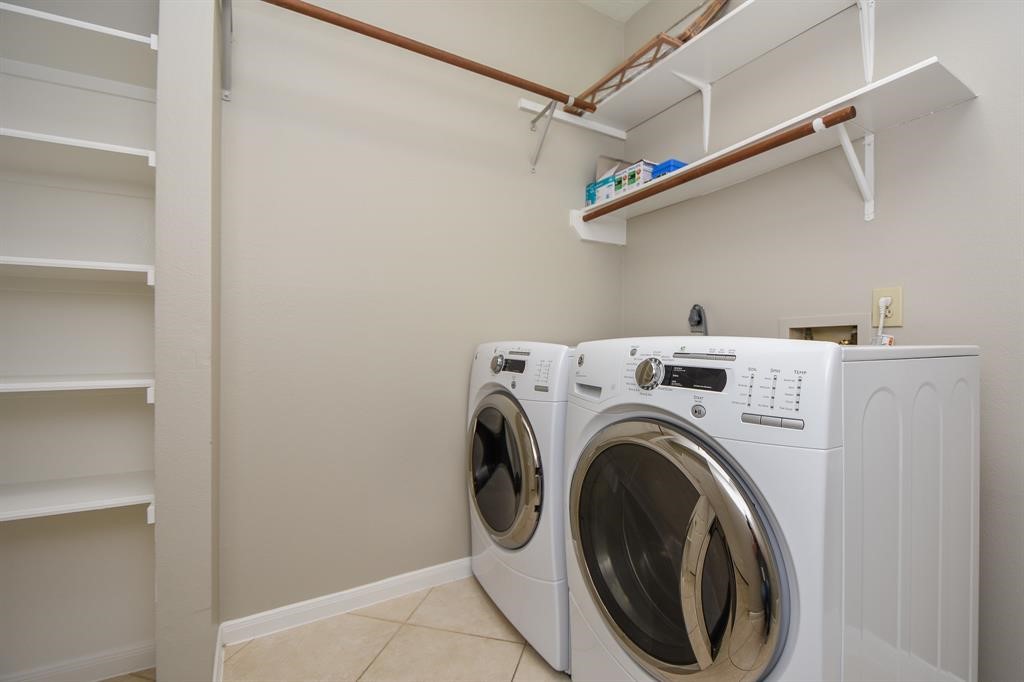 27 West Rumple Creek Place Spring, TX 77381 - Photo 27 of 32 The utility room includes a washer and dryer.