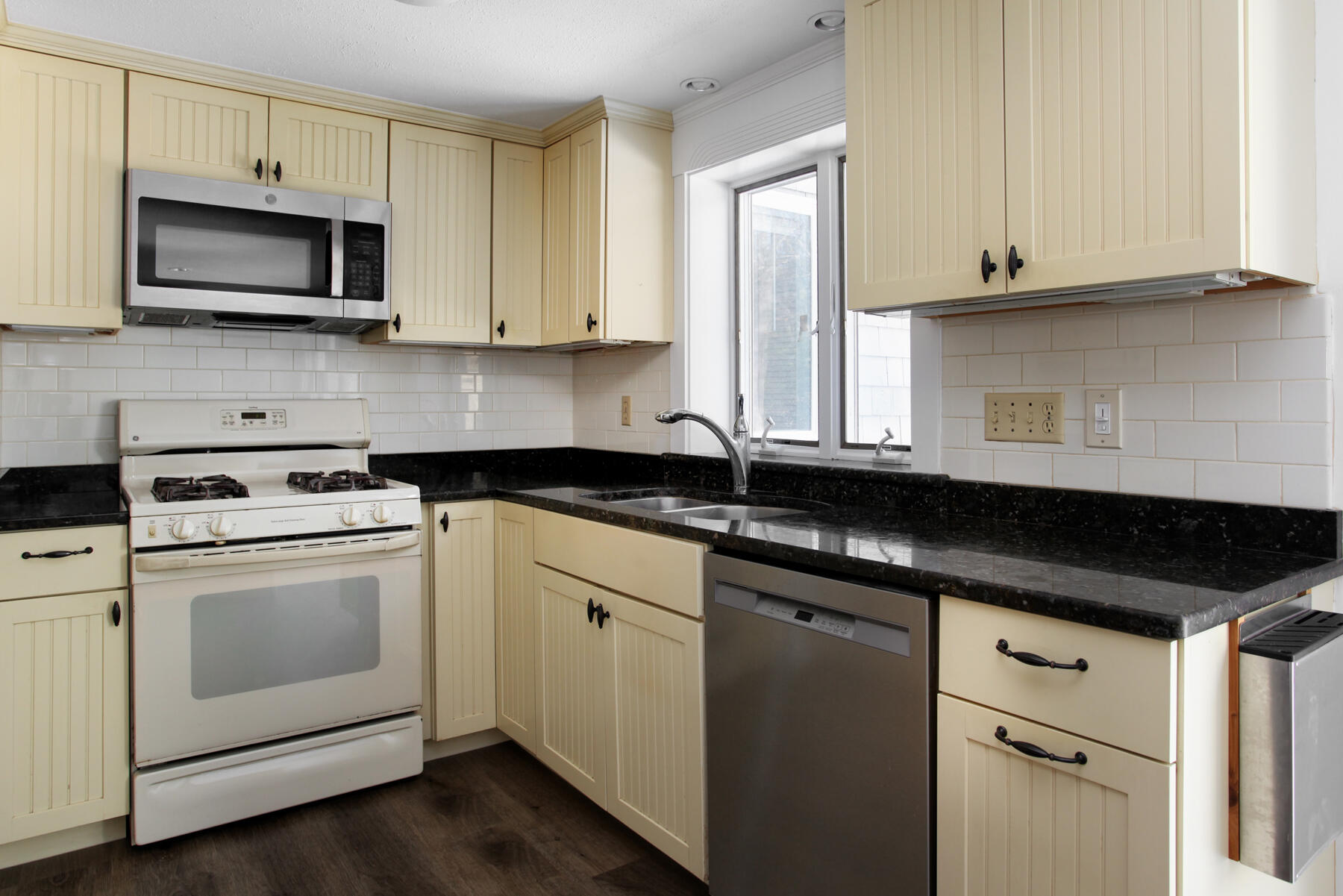 36 Tuckernuck Road Centerville, MA 02632 - Photo 12 of 45 a kitchen with stainless steel appliances granite countertop a sink a stove a microwave and cabinets