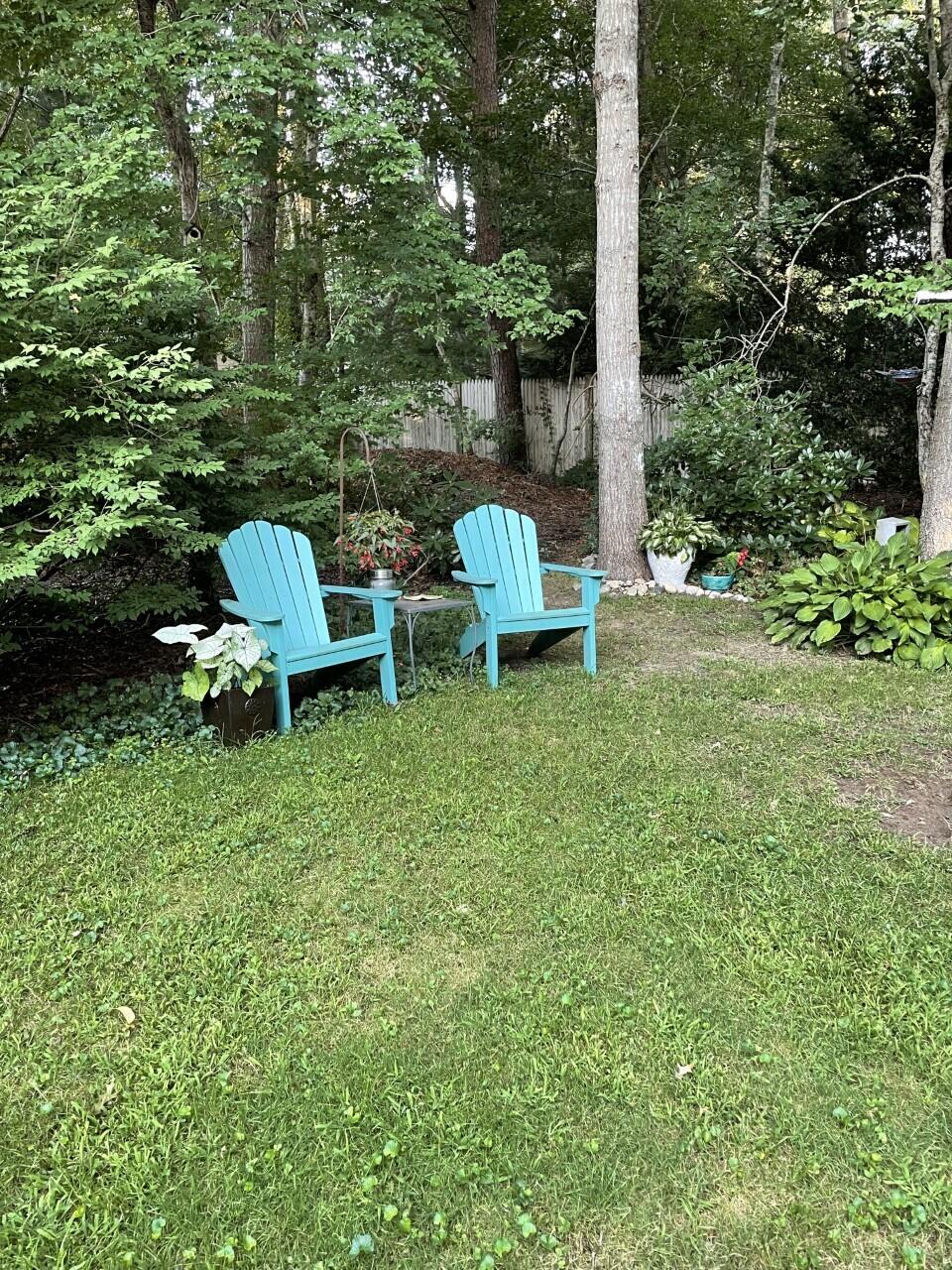 36 Tuckernuck Road Centerville, MA 02632 - Photo 36 of 45 a view of a wooden bench sitting in the middle of a garden