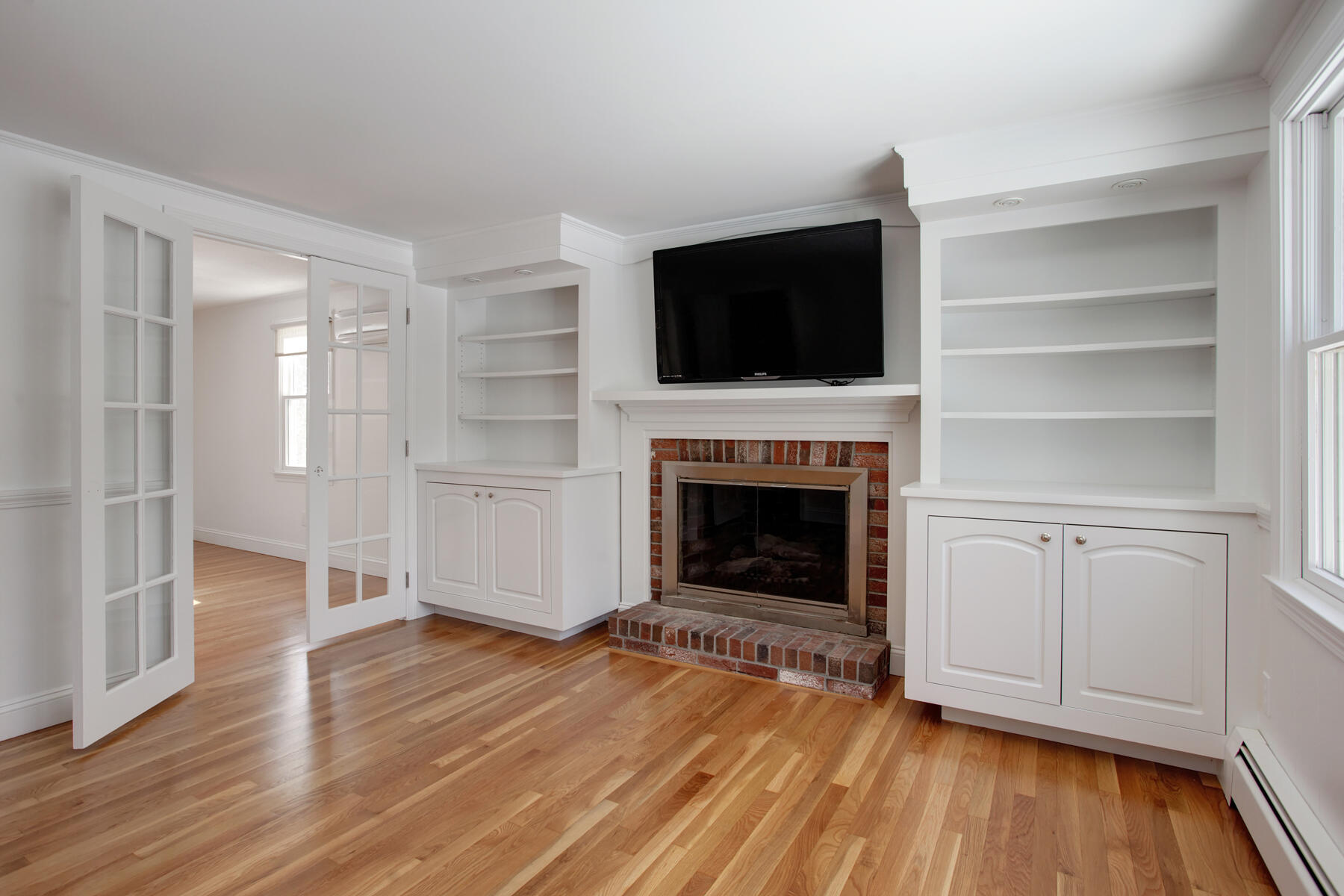 36 Tuckernuck Road Centerville, MA 02632 - Photo 9 of 45 a view of a livingroom with wooden floor a fireplace and a window