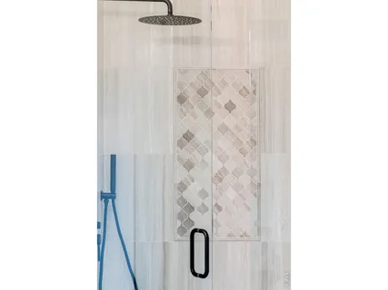 a bathroom with a glass shower door